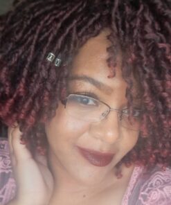 CEO wearing burgundy dreadloc synthetic wig