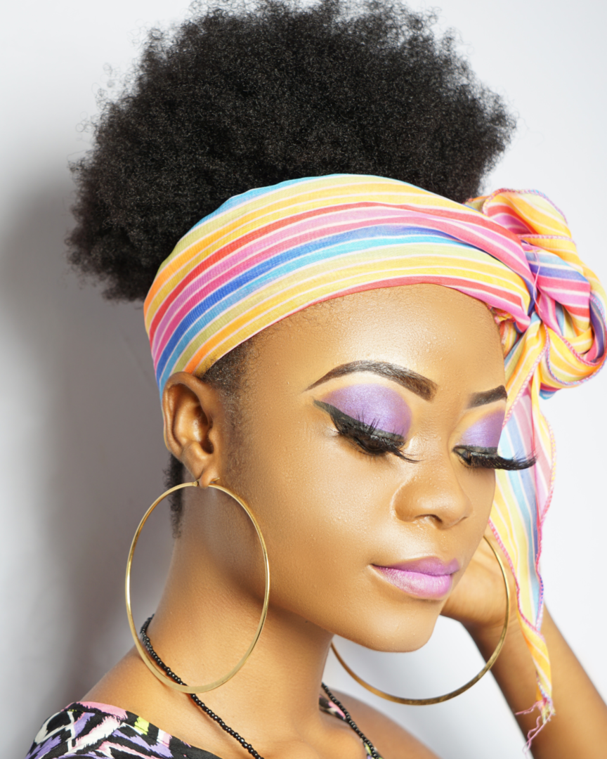 Girl with colorful head scarf with lash extensions