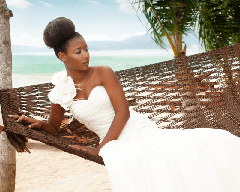 Beautiful bride posing for photos with beachy background 